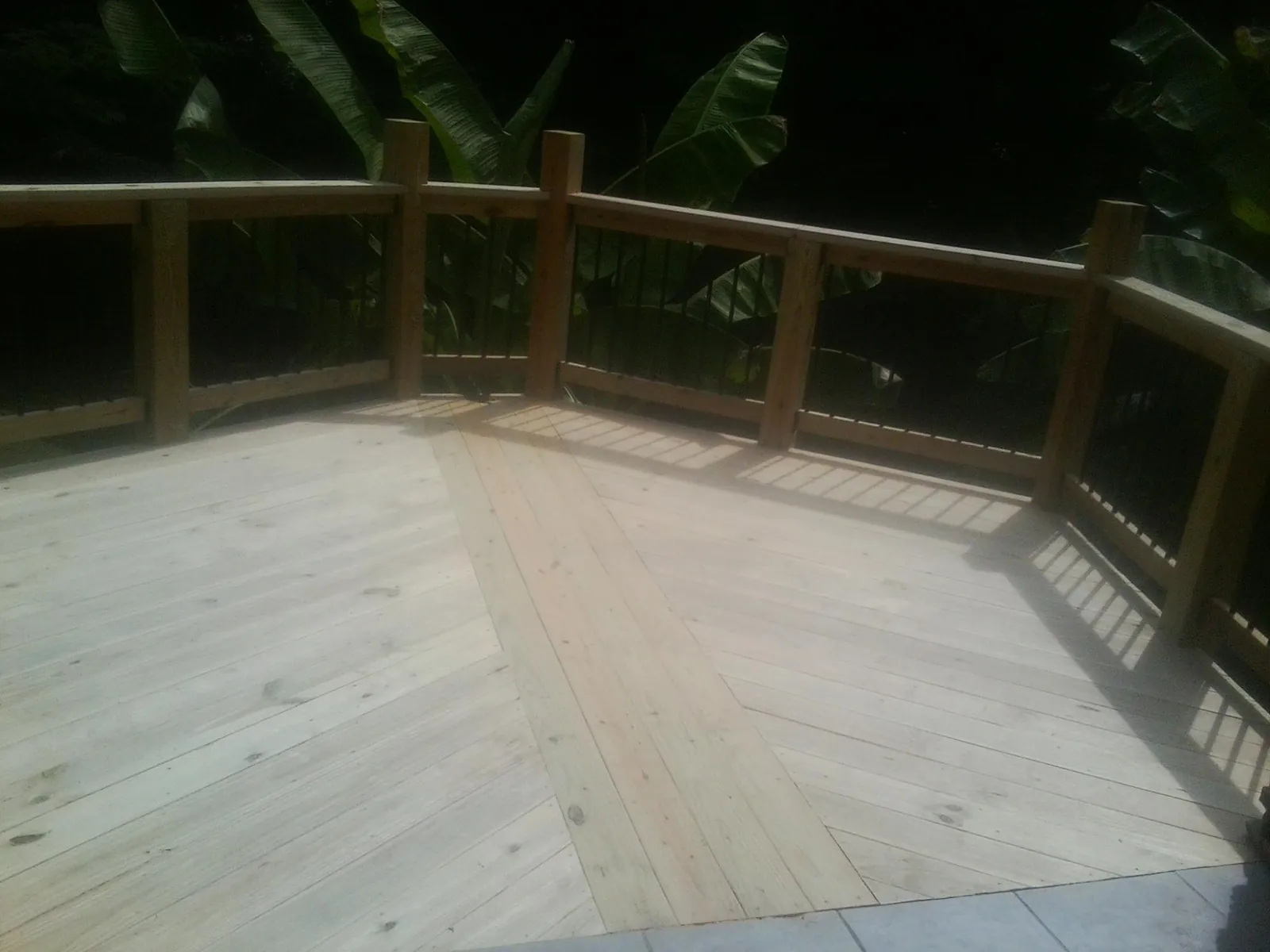 New wood deck and railing built off the back of a home in March Air Reserve Base